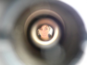 woman seen through a peephole in a front door
