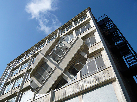 Rotating oval cut in a building facade