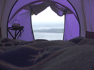 the view from a tent across a bay