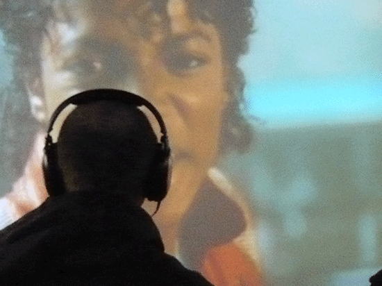 silhouette of a man wearing headphones watching a music video to Michael Jackson's music video