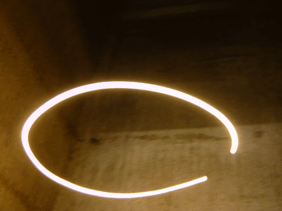 Animated GIF created from photographs of a light bulb spinning at the end of a long cable in a concrete shaft. Photographed on a long exposer and looped to giving the effect of wobbling ring of light.