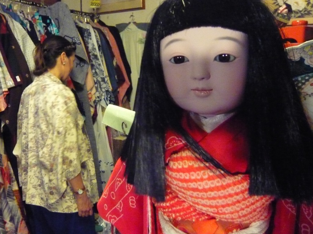 (市松人形) traditional jananese doll (Ichimatsu doll) in a second-hand kimono shop