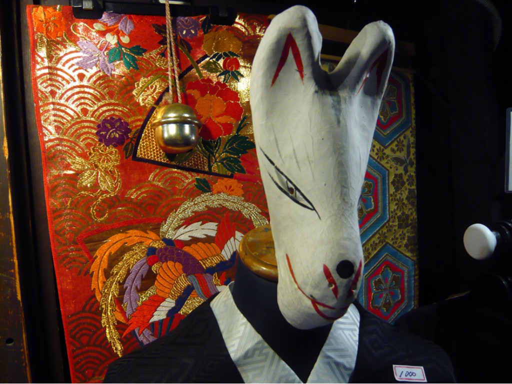 Japanese fox (Kitsune) mask on a manikin dressed outside a second-hand kimono shop 