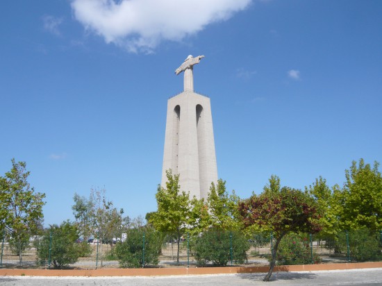  monument of  Christ the King seen across an empty car park