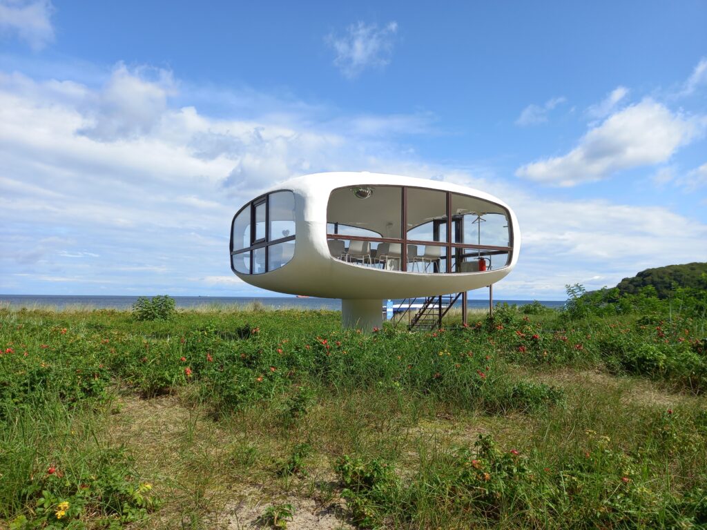 The oval tower with panorama windows looking like a "UFO", in the middle of the dunes and beach grass. 